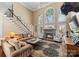 Spacious living room with tall windows, fireplace, and a large, comfortable couch at 107 Waterhouse Ct, Mooresville, NC 28117