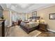Main bedroom features a tray ceiling, a large window and dark wood furnishings at 107 Waterhouse Ct, Mooresville, NC 28117