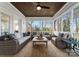 Relaxing screened-in porch with wicker furniture, ceiling fan, wood ceiling, and natural light at 107 Waterhouse Ct, Mooresville, NC 28117