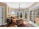 Sitting area featuring large windows, a comfortable chair and ottoman, and hardwood floors at 107 Waterhouse Ct, Mooresville, NC 28117