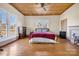Spacious bedroom with wood floors, coffered ceiling, fireplace, and large windows for natural light at 121 York St, Chester, SC 29706