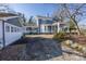 Charming blue home featuring a wrap-around porch, detached garage, and well-maintained driveway at 121 York St, Chester, SC 29706