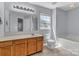 Bright bathroom featuring a wooden vanity, large mirror, and a window for natural light at 1218 Faversham Ln, Rock Hill, SC 29730