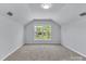 Spacious bedroom with neutral carpet, white walls, and a window with a view of greenery at 1218 Faversham Ln, Rock Hill, SC 29730