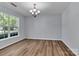 Bright dining room with hardwood floors, large window, and a modern chandelier at 1218 Faversham Ln, Rock Hill, SC 29730