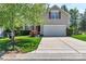 Charming two-story home with a well-maintained lawn, mature landscaping, and an attached two-car garage at 1218 Faversham Ln, Rock Hill, SC 29730