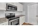 Kitchen includes stainless steel appliances, microwave, stove, and white cabinetry at 1218 Faversham Ln, Rock Hill, SC 29730