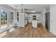 Eat-in kitchen featuring white cabinets, stainless steel appliances, island, and access to the deck at 1218 Faversham Ln, Rock Hill, SC 29730