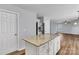 Open kitchen layout with granite island, stainless steel refrigerator, and access to living area at 1218 Faversham Ln, Rock Hill, SC 29730