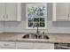 Kitchen sink featuring granite countertops, subway tile backsplash, and a window view at 1218 Faversham Ln, Rock Hill, SC 29730