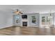 Bright living room with a cozy fireplace, ceiling fan, and access to an outdoor deck at 1218 Faversham Ln, Rock Hill, SC 29730