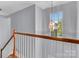 Staircase with wooden railing and pendant light fixture above at 1218 Faversham Ln, Rock Hill, SC 29730