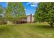 Serene backyard showing a deck, lush lawn and mature trees at 1260 Summer Ln, Salisbury, NC 28146