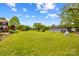 Large backyard featuring mature trees, a shed and a swing set at 1260 Summer Ln, Salisbury, NC 28146