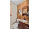 Rustic bathroom featuring wood paneling, a classic vanity, and decorative wall art at 1260 Summer Ln, Salisbury, NC 28146