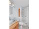 Well-lit bathroom featuring a white shower, light blue walls, and a wooden vanity at 1260 Summer Ln, Salisbury, NC 28146