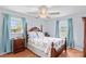Charming bedroom featuring two windows with blue curtains and a wooden bed frame at 1260 Summer Ln, Salisbury, NC 28146