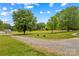 Long driveway leads to a home with a spacious yard and mature landscaping at 1260 Summer Ln, Salisbury, NC 28146