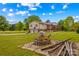 Charming raised ranch with two-car garage, spacious deck, and fire pit on a large, well-manicured lawn at 1260 Summer Ln, Salisbury, NC 28146