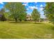 Charming home nestled among mature trees, surrounded by lush landscaping at 1260 Summer Ln, Salisbury, NC 28146