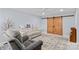 Cozy living room featuring a light gray sofa, a decorative rug and wooden sliding doors at 1260 Summer Ln, Salisbury, NC 28146