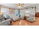 Spacious living room featuring a plush sofa, patterned chairs, and hardwood flooring for a cozy atmosphere at 1260 Summer Ln, Salisbury, NC 28146