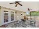 Covered porch area featuring a patterned rug, rocking chairs, ceiling fans and backyard views at 1260 Summer Ln, Salisbury, NC 28146