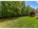 Expansive grassy backyard bordered by mature trees, with room for recreation and relaxation at 174 Buffalo Creek Dr, Statesville, NC 28677
