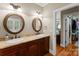 Dual vanity bathroom with framed mirrors and access to the walk in closet at 174 Buffalo Creek Dr, Statesville, NC 28677