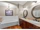 Bathroom features a soaking tub, double sinks, and stylish light fixtures at 174 Buffalo Creek Dr, Statesville, NC 28677