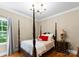 Bedroom features a four poster bed, hardwood floors, and traditional decor at 174 Buffalo Creek Dr, Statesville, NC 28677