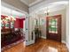 Elegant foyer featuring hardwood floors, arched doorways, and a glimpse into the formal dining room at 174 Buffalo Creek Dr, Statesville, NC 28677