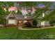 Charming home with well-manicured lawn and orange door, framed by a beautiful, colorful sky at 174 Buffalo Creek Dr, Statesville, NC 28677