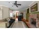 Cozy living room features a brick fireplace and view to front door at 174 Buffalo Creek Dr, Statesville, NC 28677
