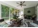 Inviting screened porch featuring wicker furniture, a ceiling fan, and outdoor views at 174 Buffalo Creek Dr, Statesville, NC 28677