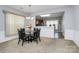 Cozy dining area featuring a glass table with chairs, natural light, and an open connection to the kitchen at 18020 Owl Ct, Indian Land, SC 29707