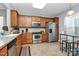 Well-equipped kitchen featuring stainless steel appliances, tile backsplash, wood cabinetry, and a breakfast bar at 18020 Owl Ct, Indian Land, SC 29707