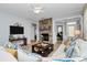 Comfortable living room features a stone fireplace, neutral colors, and an open layout perfect for relaxation at 18020 Owl Ct, Indian Land, SC 29707
