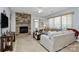 Inviting living room featuring a stone fireplace, comfortable seating, and large windows for natural light at 18020 Owl Ct, Indian Land, SC 29707