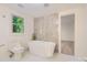 A modern bathroom featuring a freestanding tub, and modern fixtures at 200 Kimrod Ln, Charlotte, NC 28270