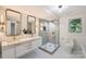 Bright bathroom with dual vanities, a glass-enclosed shower, and modern fixtures at 200 Kimrod Ln, Charlotte, NC 28270