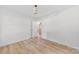 Well-lit bedroom featuring wood-look floors, closet doors, and neutral walls at 200 Kimrod Ln, Charlotte, NC 28270
