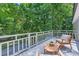 Deck furnished with chairs, and a view of the lush surrounding trees at 200 Kimrod Ln, Charlotte, NC 28270