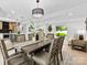 Bright dining room featuring a modern light fixture, dining table and view to kitchen and outdoors at 200 Kimrod Ln, Charlotte, NC 28270