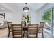 Dining room featuring a wooden table with upholstered chairs and a sliding glass door to an outdoor area at 200 Kimrod Ln, Charlotte, NC 28270