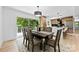 Bright dining room featuring a modern light fixture, dining table and view to kitchen and deck at 200 Kimrod Ln, Charlotte, NC 28270