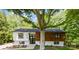 Charming renovated home with a mix of wood and white painted brick exterior and a beautiful front yard at 200 Kimrod Ln, Charlotte, NC 28270