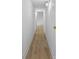Neutral hallway with light wood floors, white trim, neutral paint, and modern light fixtures at 200 Kimrod Ln, Charlotte, NC 28270