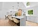 Bright kitchen with quartz island and counters, pendant lighting, stainless appliances, and dining area at 200 Kimrod Ln, Charlotte, NC 28270