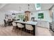 Bright, modern kitchen with an island bar, skylight, pendant lighting, and open view to the dining area at 200 Kimrod Ln, Charlotte, NC 28270
